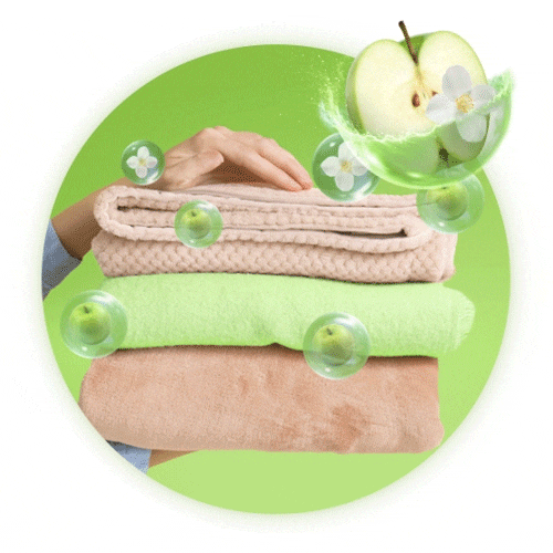 Ropa limpia y doblada suavemente con aroma a manzana verde y flores blancas de Suavitel Cuidado Superior.
